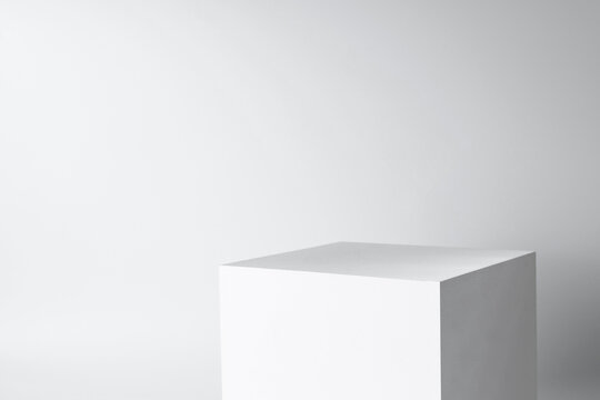 blank mockup template empty square box platform pedestal cube to display isolated white clean background with grey shadow wall