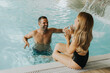 © BGStock72 - Young couple having fun in the indoor swimming pool