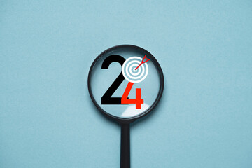 Wall Mural - 2024 year with dartboard inside of magnifier glass for focusing in objective target include business