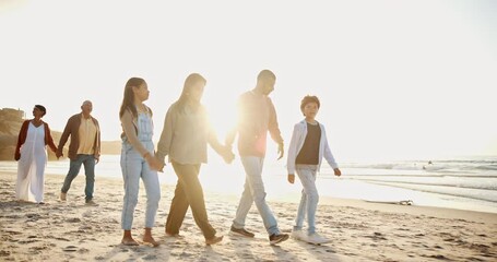 Wall Mural - Sunset, walking and family holding hands on the beach for travel vacation, holiday or weekend trip together. Evening, freedom and people on sand by the ocean or sea for tropical getaway on an island