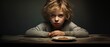 Unhappy little boy does not want to finish eat his food on dramatic background