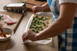 © weyo - The cook rolls puff pastry with bacon, spinach and cheese, prepares mini pizza cakes.