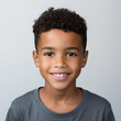 © Lui Shtein - portrait of a cute smiling african american boy wearing a shirt. emotional portrait. on a white background