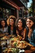 Smiling group of young hispanic women eating outdoors on terrace