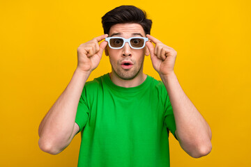 Canvas Print - Portrait of impressed guy wear stylish t-shirt touching 3d glasses staring at modern visual effects isolated on yellow color background