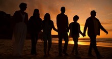 Sunset, Walk And Silhouette Of Family At The Beach On A Summer Vacation, Holiday Or Weekend Trip. Travel, Evening And Shadow Of People Holding Hands By The Ocean Or Sea On Tropical Getaway Together.