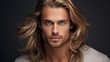 Elegant sexy smiling Caucasian blond man with blond and long hair with perfect skin, on a gray background, banner.