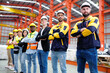 © krongthip - The engineering team and employees are happy to wear safety helmets. Smiling, happy working in the factory.