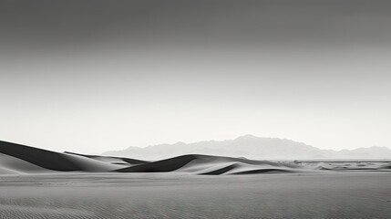 Wall Mural -  a black and white photo of a desert with sand dunes and mountains in the distance with dark clouds in the sky and a lone lone tree in the foreground.