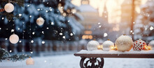 Christmas Decorations On A Snow-covered Bench Against The Backdrop Of A New Year's Holiday Landscape. Banner Or Mockup. Congratulatory, New Year Or Christmas Landscape Background.