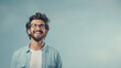 © Ai Studio - Joyful young man with glasses looking up, smiling against a soft blue background, radiating positivity and aspiration