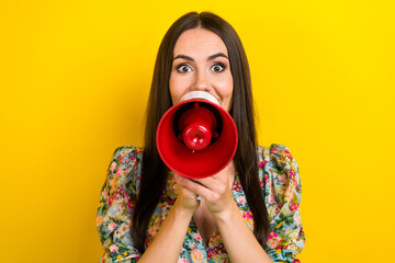 Sticker - Photo of impressed girl with long hairdo dressed flower print blouse announcing sale in loudspeaker isolated on yellow color background