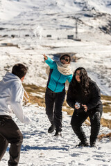 laughter echoes as this latino family enjoys a playful snowball fight amidst the stunning snowy land