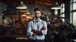 © Bilal - Portrait of a confident young Indian businessman standing with arms crossed in a factory