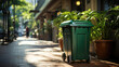 Green garbage bin on a city sidewalk.