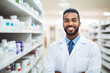 Welcoming black male pharmacist in lab coat standing in pharmacy aisle