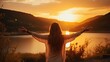 woman posing with her back facing mountains on sunset in nature with open hands. silhouette summer landscape. Freedom Concept
