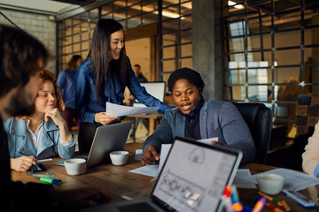 Wall Mural - Young business partners having meeting in office