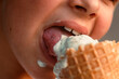© masyastadnikova - Close-up view of a boy eating ice cream in a waffle cup. Macro. Detailed view of a tongue in ice cream, Summer time, happy childhood. High quality photo