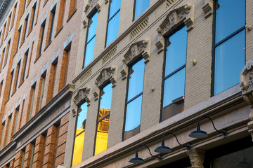 Exterior view of historic building with glass windows, sky reflection in downtown Grand Rapids, Michigan