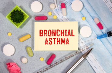 Wall Mural - In the notebook is the text bronchial asthma, next to a stethoscope, pills and glasses.