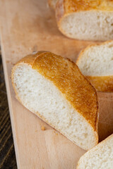 Wall Mural - wheat loaf of bread close-up on the table