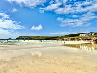 Poster - the beach is clean and empty with people walking along it