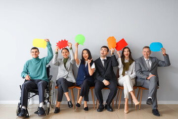 Sticker - Business people with speech bubbles sitting near light wall