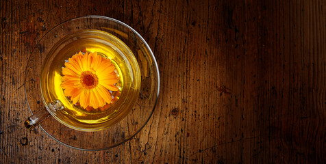 Wall Mural - marigold tea on a wooden table