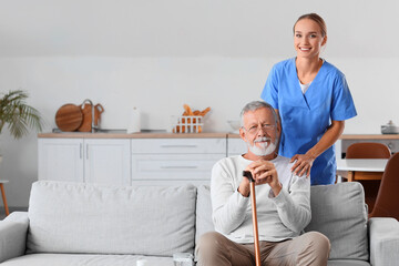 Senior man with walking stick and nurse at home