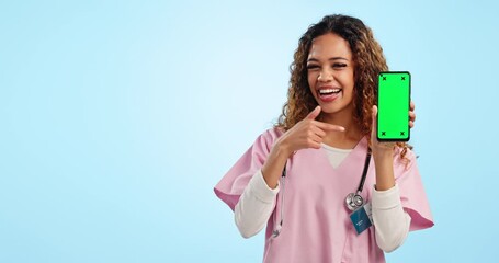 Poster - Mockup, green screen and portrait of woman doctor pointing at phone in studio for advice, info or contact. Smile, chromakey and nurse with online review, feedback or medical guide on blue background.