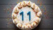Joyful eleventh birthday cake with vibrant icing and number 11 topper, captured from above for memories.