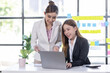 © David - Team of confident asian business women point to graphs and charts to analyze market data, balance sheet, account, net profit to plan new sales strategies to increase production capacity.
