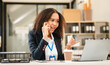 © makibestphoto - African American businesswoman, focused on her work on a laptop, possibly managing industrial production tasks.