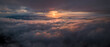 Panorama shot of colorful light of sunrise over rainforest mountains with fog and cloud inversion for natural cinematic of national park and wildlife reserve area