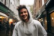 man is in a white hoodie moving and smile, movement and spontaneity, london street background. generative AI