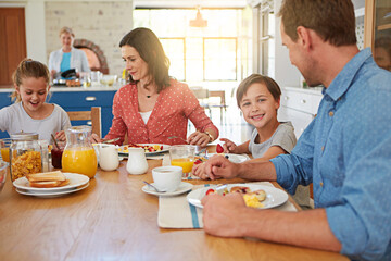 Poster - Food, breakfast and love with a family in the dining room of their home together for nutrition. Portrait of a boy with his parents and sister eating at a table in an apartment for morning bonding