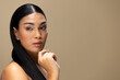 © Wavebreak Media - Portrait of biracial woman with dark hair and natural make up on brown background, copy space
