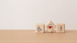 house with red heart  inside  wooden cube block and elderly and disability person icon, including copy space, for home or nursing care for aging people concept