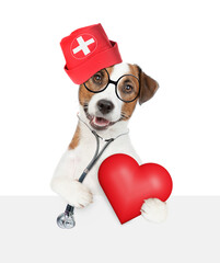 Aufkleber - Clever jack russell terrier wearing like a doctor with stethoscope on his neck looks above empty white banner and holds red heart. isolated on white background