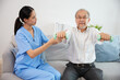 © offsuperphoto - nurse or caregiver helping elderly patient to physiotherapist and exercise for rehabilitation at home