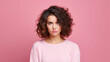 Photo of unhappy young woman bad mood irritated problem raise eyebrow isolated on pink color background. Made with generative ai