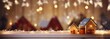 Gingerbread house with glaze standing on table with Christmas decorations, candles and lanterns bokeh lights