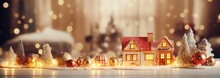 Gingerbread House With Glaze Standing On Table With Christmas Decorations, Candles And Lanterns Bokeh Lights