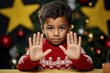 © IlluGrapix - Surprised boy is holding a gift box near Christmas tree, kid wearing hat while holding a Christmas gift