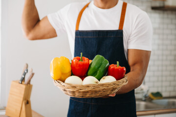 Fresh bell pepper holding by hand mixed salad