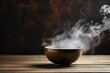 Steaming Bowl of Hot Tea on Rustic Wood Background. Atmospheric Smoke and Steam Rise from Dark Black Bowl of Delicious, Ready-to-Eat Food and Drink