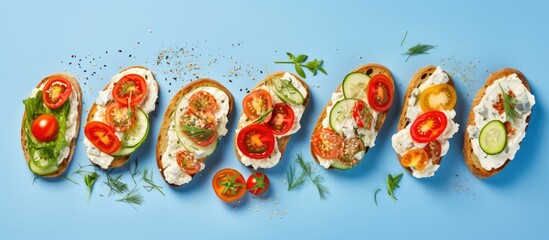 Healthy eating concept variety of open faced sandwiches on rye bread with cream cheese ricotta cherry tomatoes red pepper cucumber slices and dry herbs Copy space image Place for adding text or