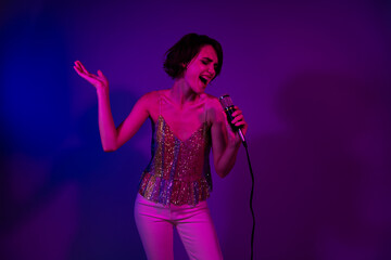 Wall Mural - Photo of crazy lady pop star singing in nightclub stage on new year christmas isolated neon color background