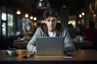 © standret - Male teenager working by his laptop indoors in the caf?